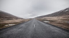 hills asphalt gray puddle overcast road landscape long road