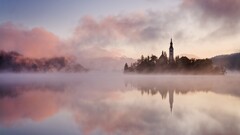 lake bled Slovenia mist pink sunrise reflection calm waters