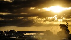 nascar dappled sunlight race cars race tracks sun rays sunset