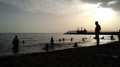 Sea beach sunset group of people