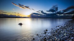 sunset pebbles clouds rock Seattle beach Washington State water