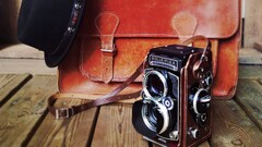camera old bag vintage hat wooden surface