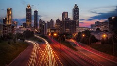 cityscape building lights long exposure light trails highway