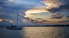 coast sky boat water clouds