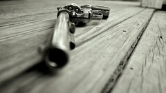 gun closeup revolvers weapon gray wooden floor monochrome