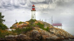 lighthouse rock clouds overcast