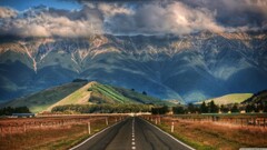 Mountains clouds sunlight road New Zealand hills field