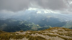 Mountains grass clouds landscape gravel far view