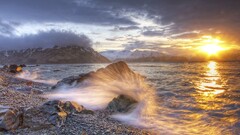 national geographic Alaska rock waves sunlight pebbles coast