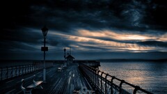 pier sky dark clouds outdoors bench water