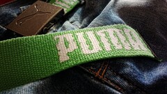 puma jeans belt closeup