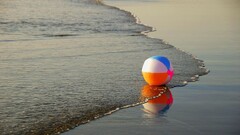 Sea waves beach ball colorful orange pink blue white sunset
