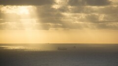 sky Sea clouds horizon sunlight sunbeams yellow ship